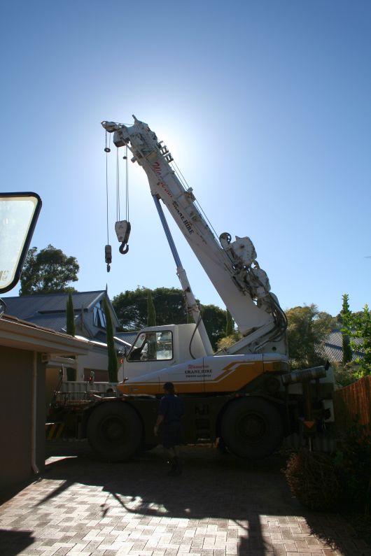 Crane to lift the spa over the roof