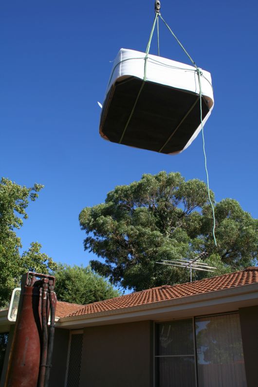 Crane to lift the spa over the roof