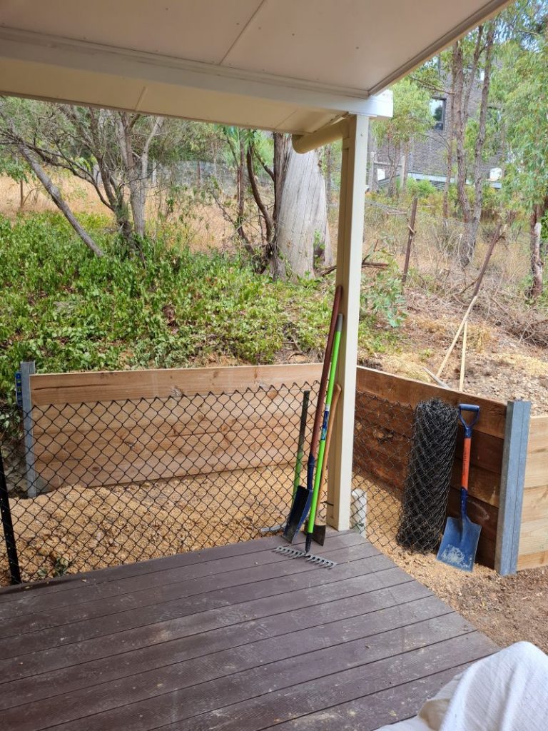 Wooden retaining wall with steel posts