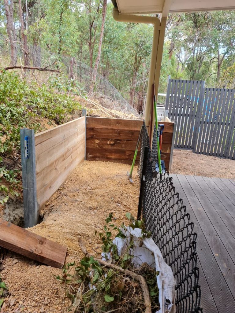 Wooden retaining wall with steel posts