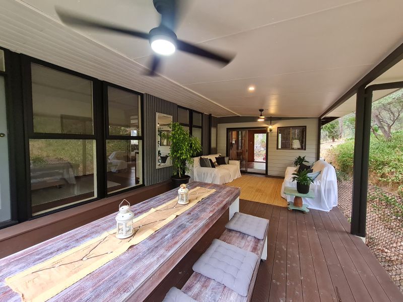 Covered verandah transformed into dining and sitting areas