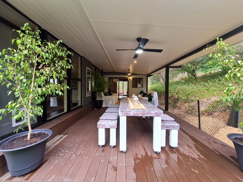 Covered verandah transformed into dining and sitting areas