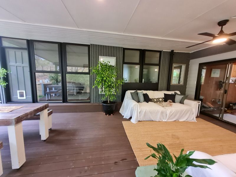 Covered verandah transformed into dining and sitting areas